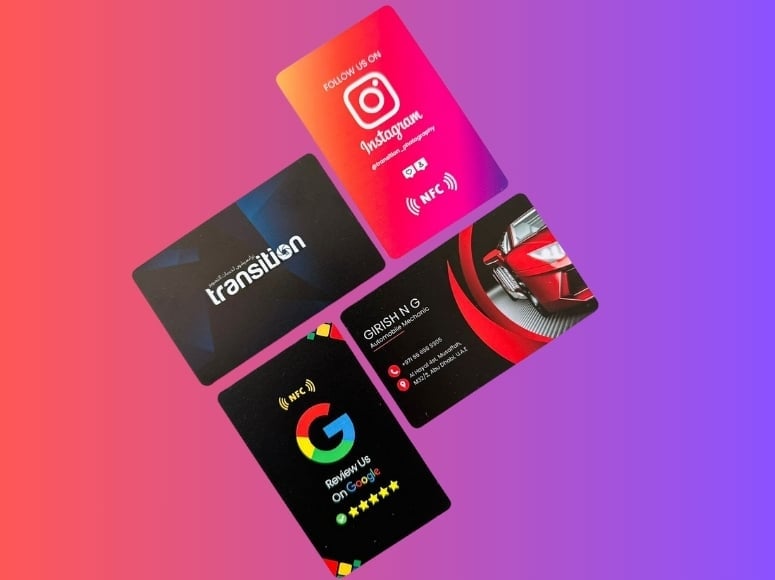 Collection of four colorful business cards displayed on a gradient pink to purple background