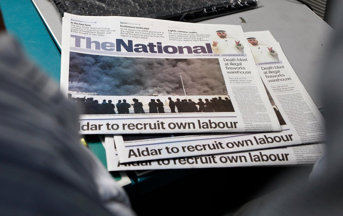 Stacked copies of The National newspaper with headline about Aldar recruiting own labour