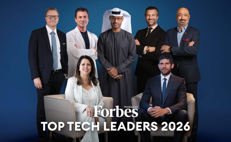 Forbes Top Tech Leaders 2026 group portrait featuring seven diverse business professionals posed against blue background