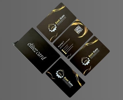 Collection of black luxury business cards and packaging with gold accents and logo designs displayed at angles