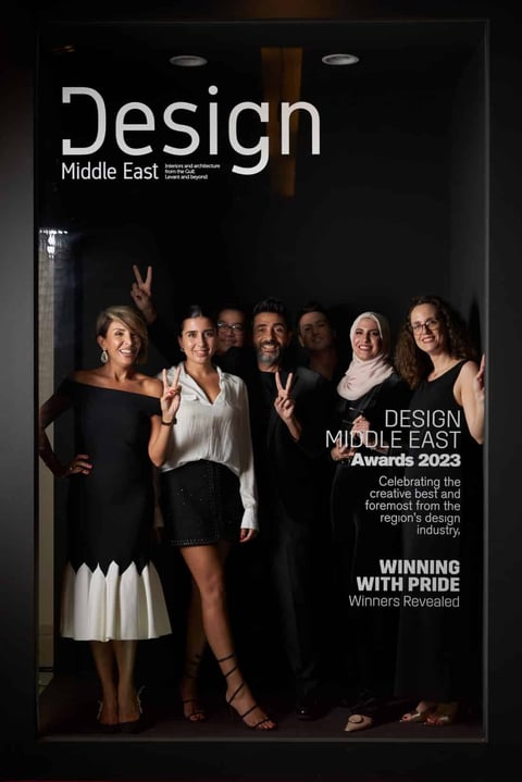 Group of six professionals posing together at Design Middle East Awards 2023 celebration event featured on magazine cover