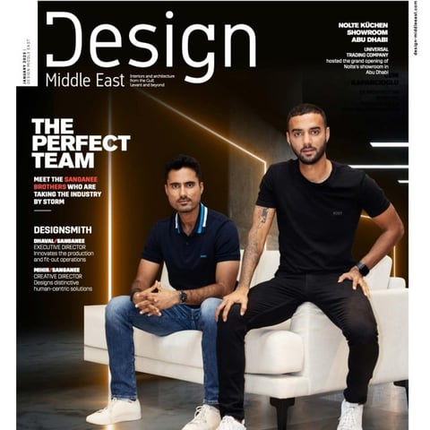 Design Middle East magazine cover featuring two men sitting on a white sofa, titled The Perfect Team